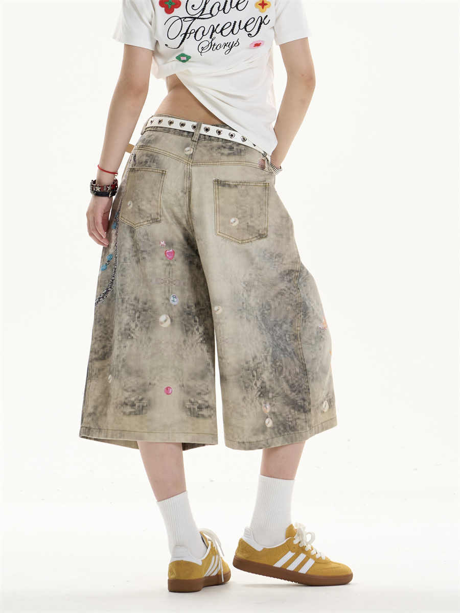 Jeans de perna larga cortados criativos com arte impressa floresça