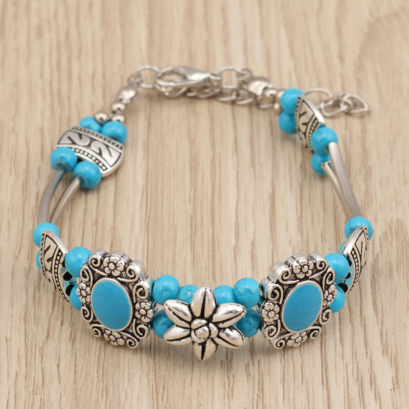 Pulsera de metal con cuentas florales